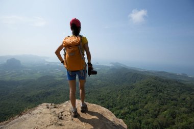 Başarılı kadın uzun yürüyüşe çıkan kimse ile uçurumun kenarında dijital fotoğraf makinesi