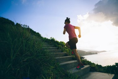 Kararlı kadın sahil dağ merdivenlerde koşma