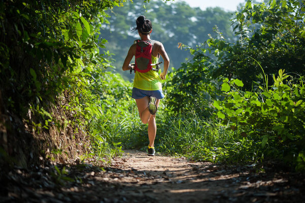 woman running at forest trail