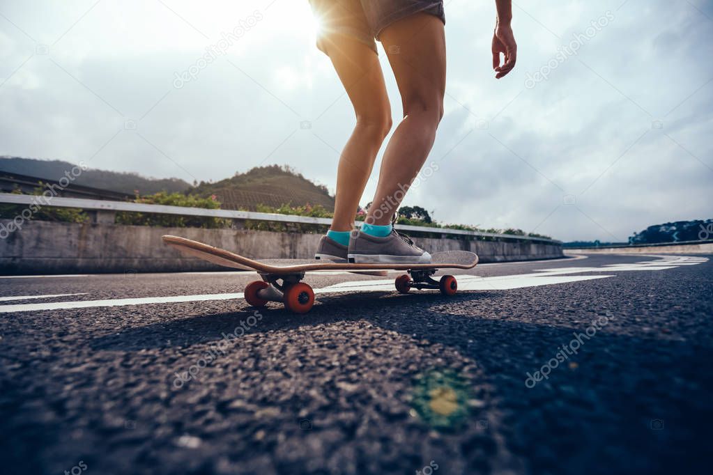 Skateboarder skateboarding on highway road