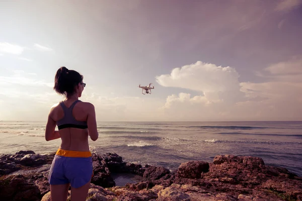 Fotografo Donna Che Controlla Drone Volante Sulla Roccia Del Mare — Foto Stock