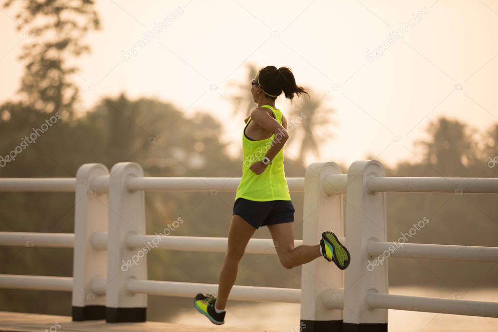 Woman runner sprinting outdoors. Sportive woman training outdoors. Healthy lifestyle and sport concepts 