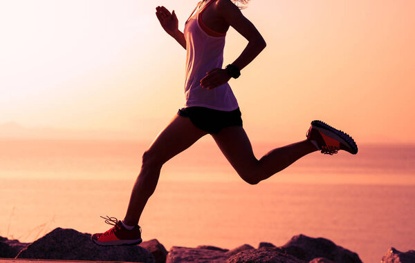 Fitness sportswoman running on sunny coast