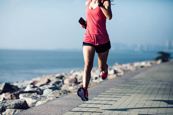 Fitness sportswoman running on sunny coast