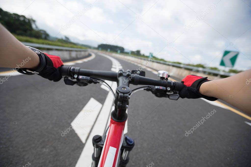 Cyclist Riding Mountain Bike on highway 