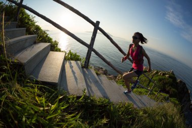 Gündoğumu deniz üst katta çalışan genç kadın iz runner
