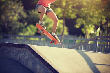 Cropped image of Skateboarder skateboarding at skatepark clipart