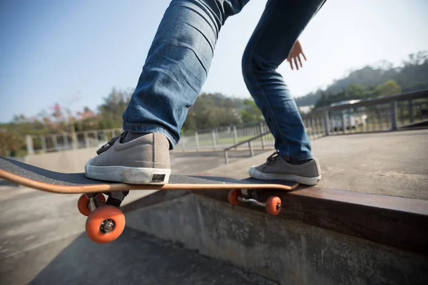 Cropped shot of skateboarder skateboarding at skatepark