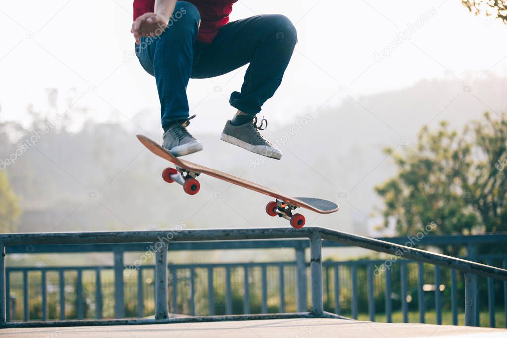 Cropped shot of skateboarder skateboarding at skatepark