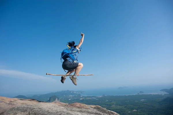 Woman Jumping Stick Rocky Mountain Peak Risk Concept — 스톡 사진