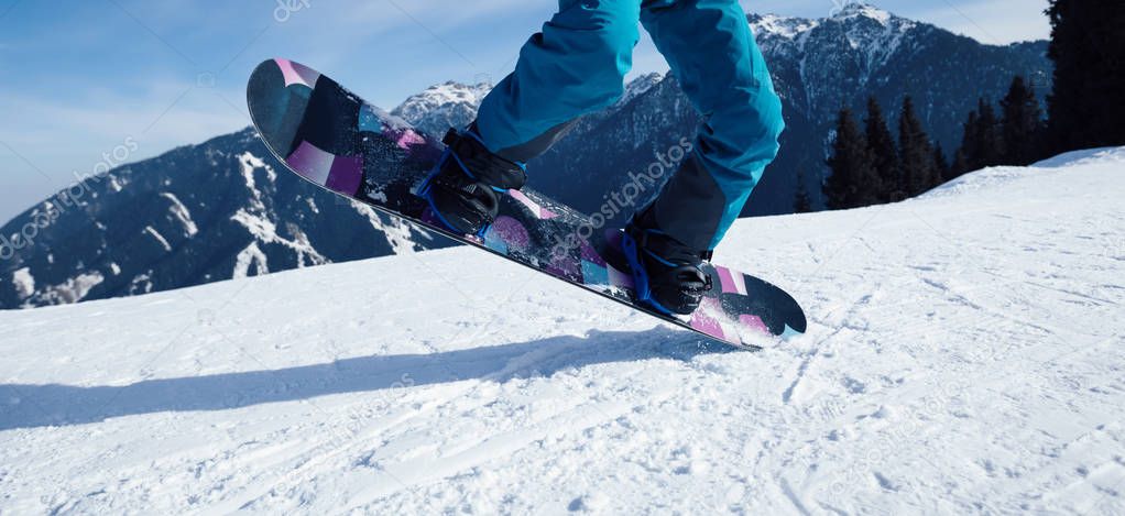 one snowboarder snowboarding jumping on slope in ski resort