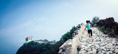 woman runner athlete cross country running on chinese great wall clipart