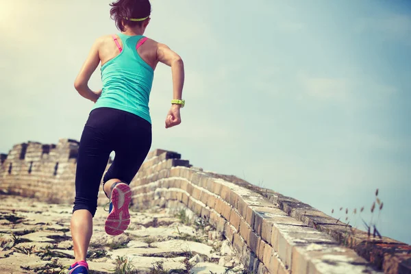 woman runner athlete cross country running on chinese great wall