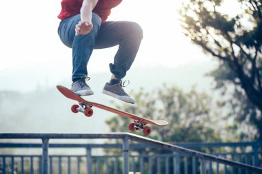 Skateboarder skateboarding at skate park ramp clipart