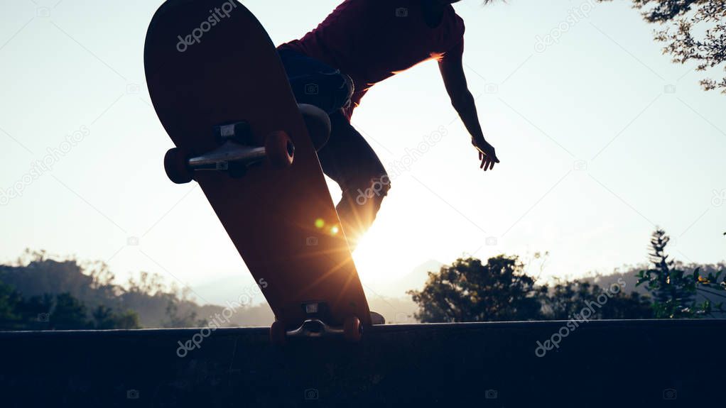 Skateboarder skateboarding at skate park ramp