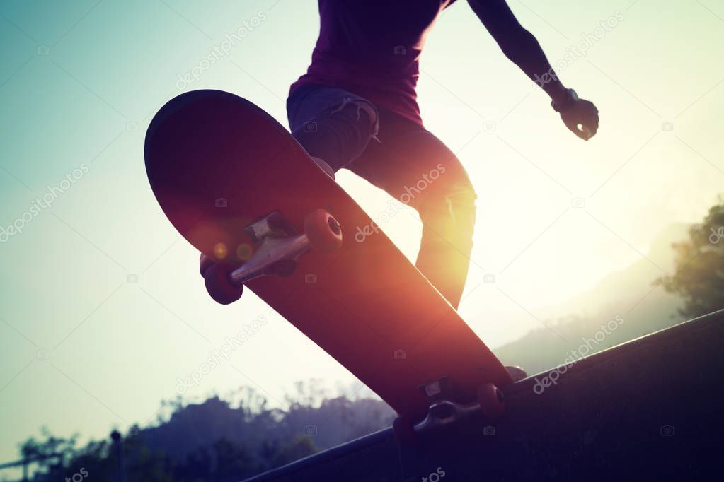 Skateboarder skateboarding at skate park ramp