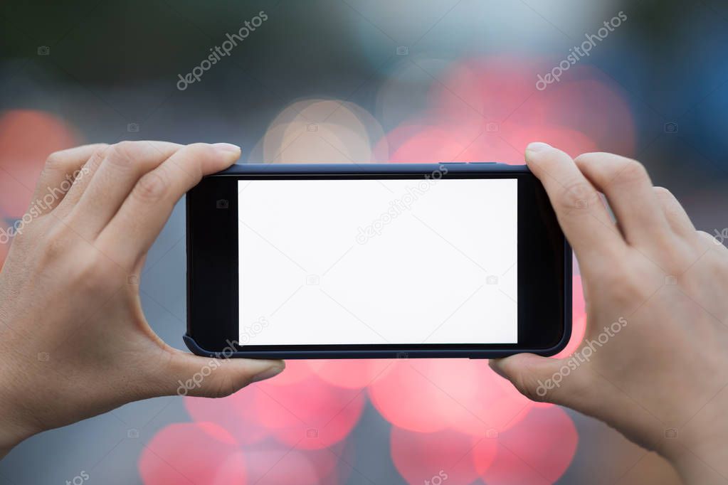 cropped view of person taking photo on cellphone in city