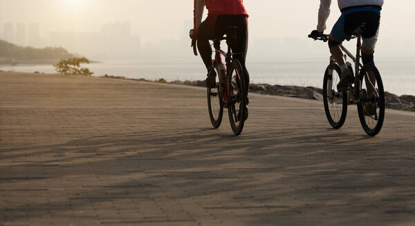 cyclists riding mountain bikes at seaside