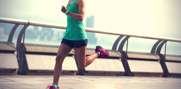 Healthy lifestyle, woman runner running on foggy city morning