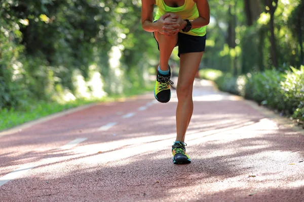 Female runner suffering with sports injury on running