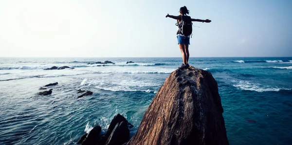 Succesvolle Jonge Vrouw Wandelaar Met Uitgestrekte Armen Seaside Rock Cliff — Stockfoto