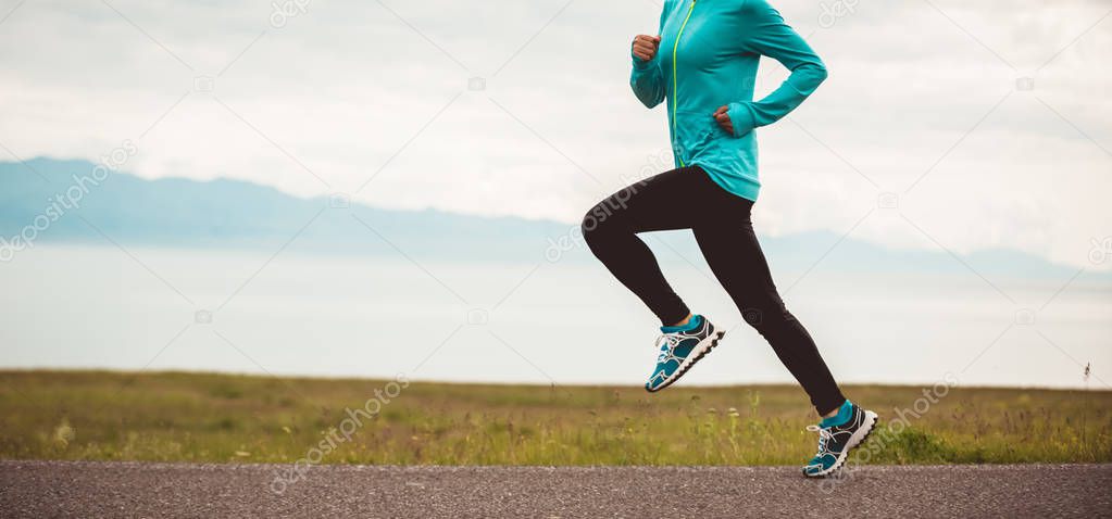Sporty young fitness woman ultramarathon runner running on road