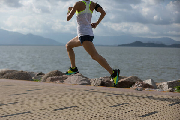 Fitness sportswoman running training for marathon on sunny coast