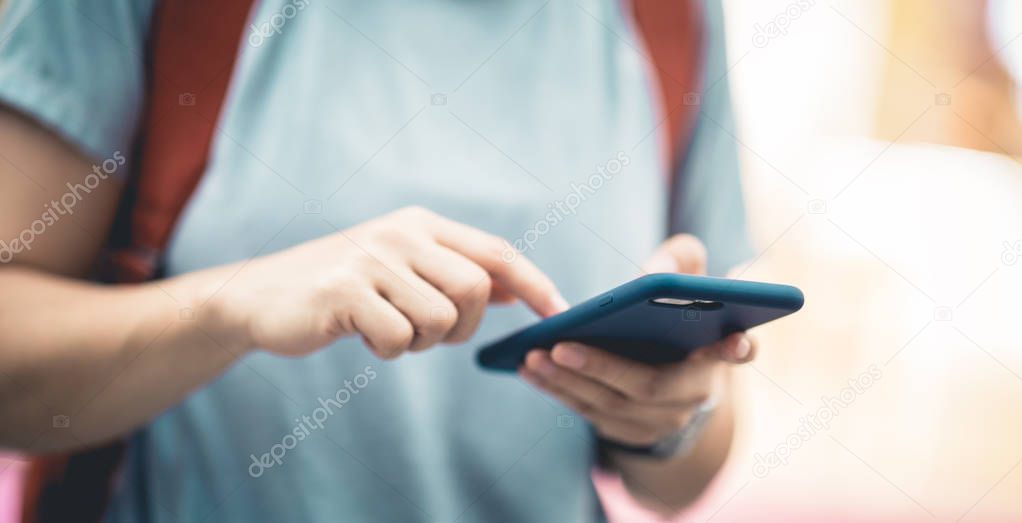 Person using smartphone on evening street