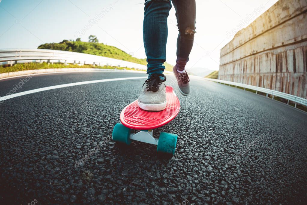 Skateboarder skateboarding on highway road