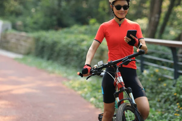 Asiatin Nutzt Smartphone Beim Fahrradfahren Sonnigen Tag — Stockfoto