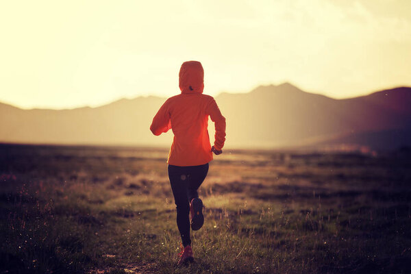 Woman trail runner cross country running outdoors