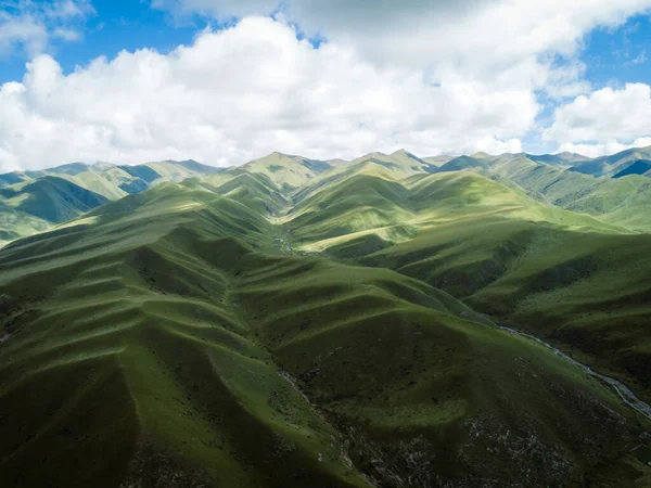 High altitude mountains with grassland landscape