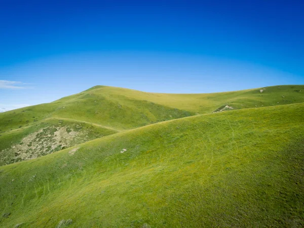 High altitude mountains with grassland landscape