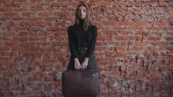 Young Girl Suitcases Her Hands Background Red Brick Background Red — Stock Video