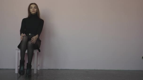 Girl Sitting Chair Standing Next Chair White Gray Background — Stock Video