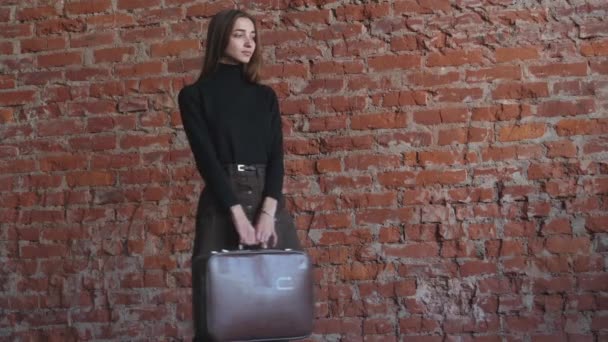 Young Girl Suitcases Her Hands Background Red Brick Background Red — Stock Video