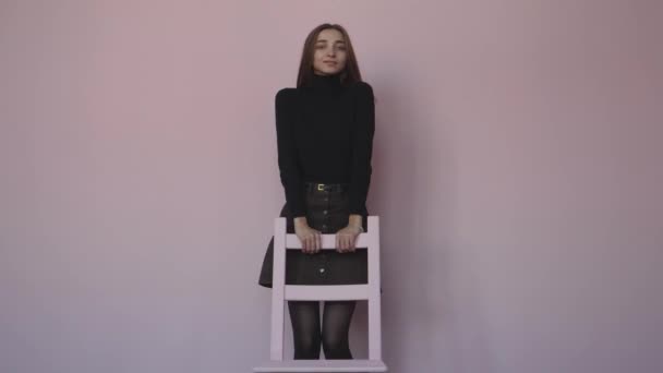 Girl Sitting Chair Standing Next Chair White Gray Background — Stock Video