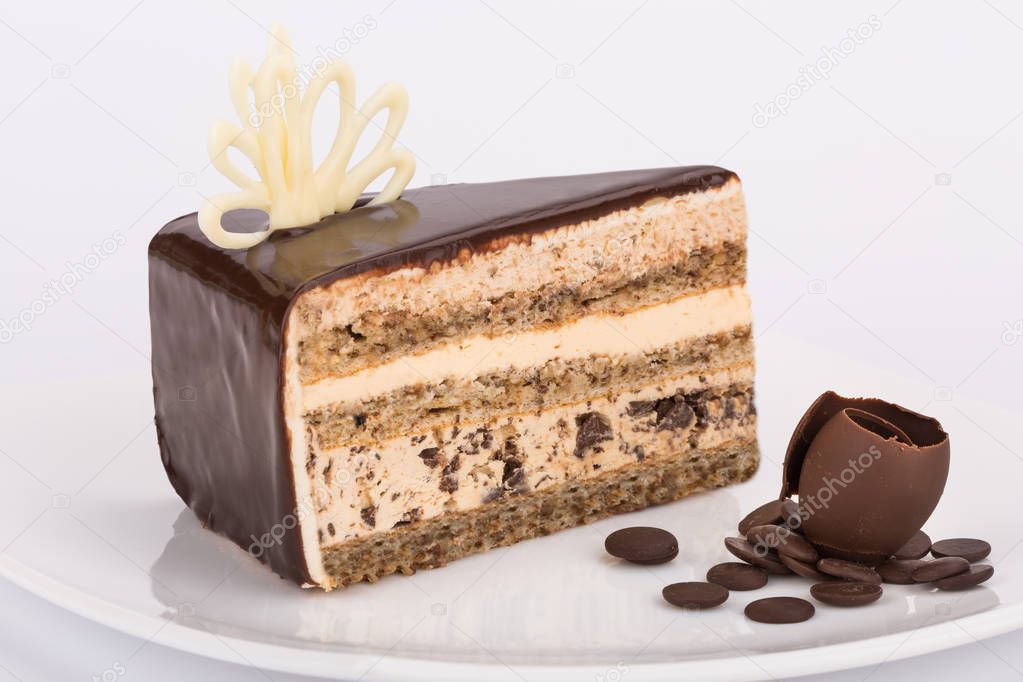Layered cake with chocolate glazing on plate