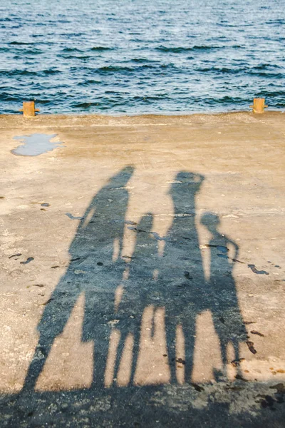 Seaside view with shadows of people