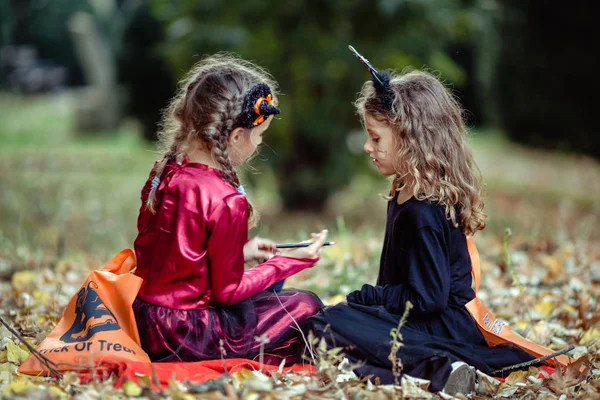 Twee Meisjes Halloween Kostuums Jurk Samen Poseren Houten Achtergrond Rechtenvrije Stockafbeeldingen