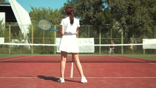 Kobieta tenisistka strzelanie piłkę do przeciwnika — Wideo stockowe
