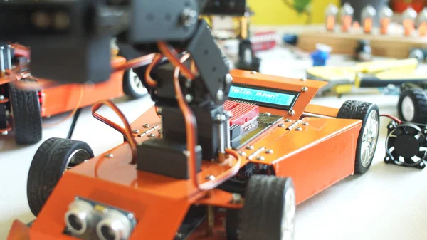 Sınıfta modern robotla oynayan genç çiftçi.