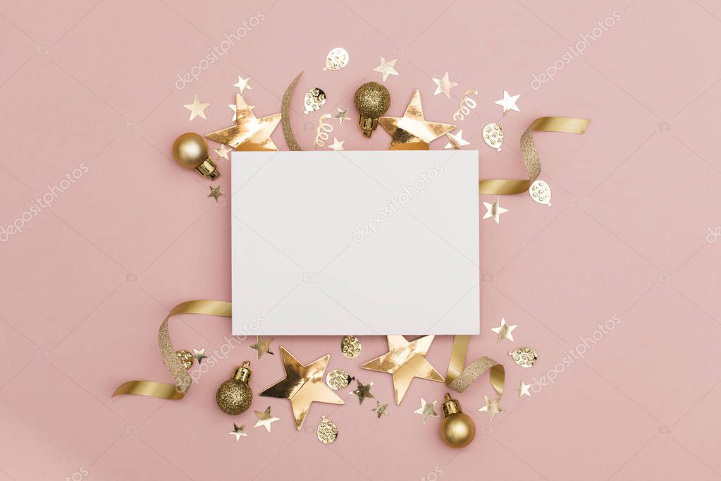 Flat lay party decoration concept on pastel pink background with blank white card