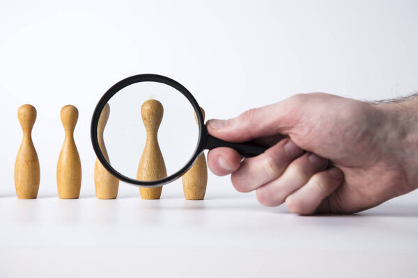 Recruitment concept. Magnifying glass with wooden people. Talent, Job, Opportunity concept