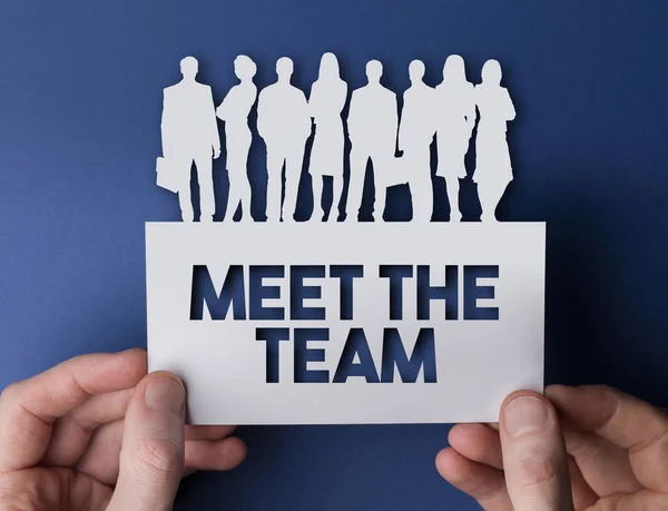 Hands holding a meet the team business people white sign. — Stock Photo, Image