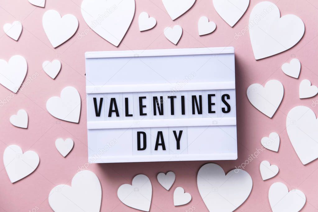 Valentines day lightbox message with white hearts on a pink background