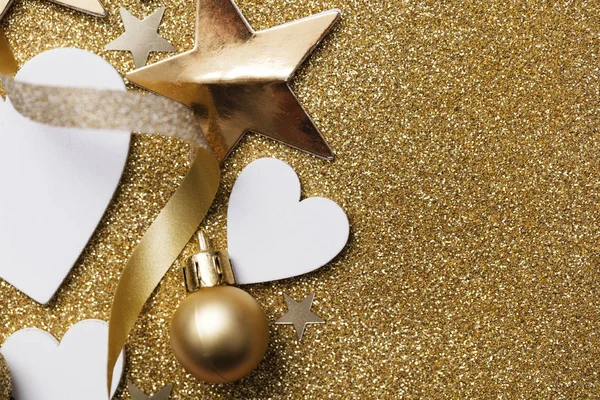 White heart shape on a golden glitter backgrond