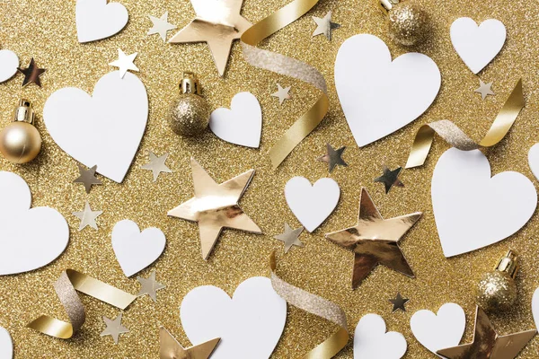 White heart shape on a golden glitter backgrond