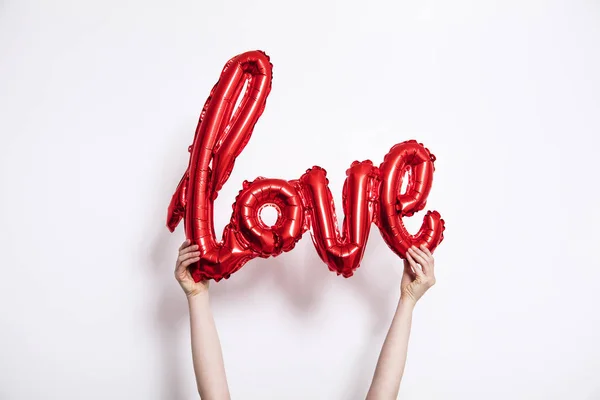 Red Foil Love Balloon Held Plain White Background — Stock Photo, Image