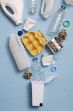 Top view of rubbish for recycling on a blue background clipart